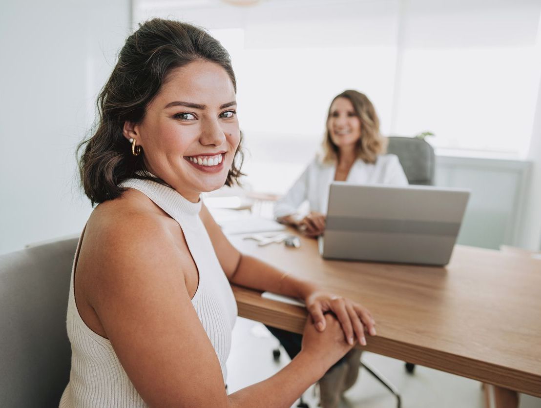 Shot of a group of businesswomen using a laptop during a meeting at work